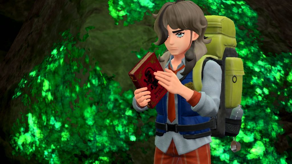 A screenshot from Pokémon Scarlet shows a trainer with the Scarlet Book. A similar book is found in Pokémon Violet.