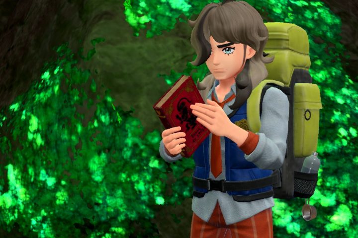 A screenshot from Pokémon Scarlet shows a trainer with the Scarlet Book. A similar book is found in Pokémon Violet.