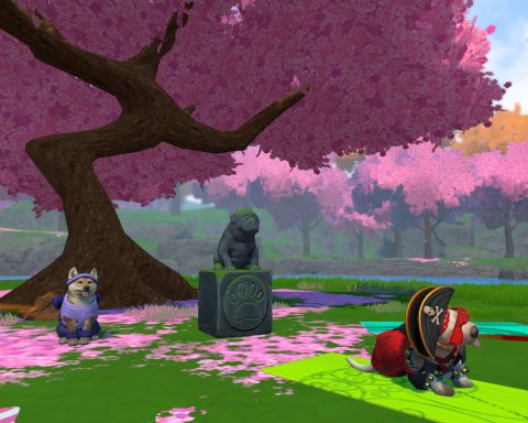 A screenshot from Little Friends: Puppy Island. Under a cherry blossom tree is a dog statue, and two dogs. One dog is dressed in workout gear, the other like a pirate.