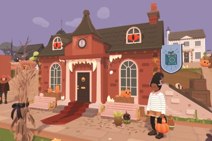 A screenshot from Ooblets' Halloween event. The town hall is adorned with spooky decorations, and two townsfolk are in costume.