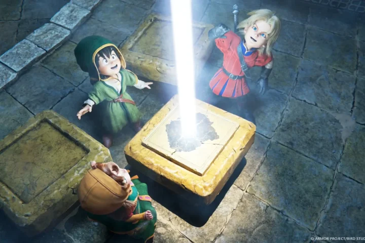 A screenshot of The Protagonist, Maribel, and Kiefer from Dragon Quest VII Reimagined. They stand around a stone pillar with a blast of white light shooting up out of it.