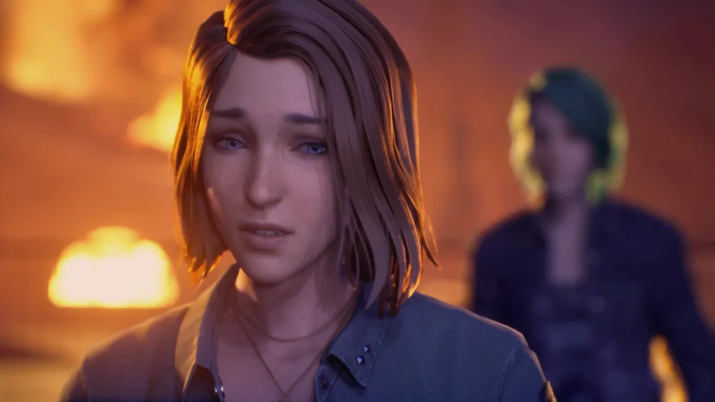 A screenshot of Max and Chloe from Life is Strange: Reunion. Max stands at the centre-left of the image, in focus. She has shoulder-length brown hair and bue eyes, and she is wearing a grey collared shirt with at least the upper buttons open. Behind her, to the right and out of focus, is Chloe. Her distinctive teal hair is her only distinguishing feature.